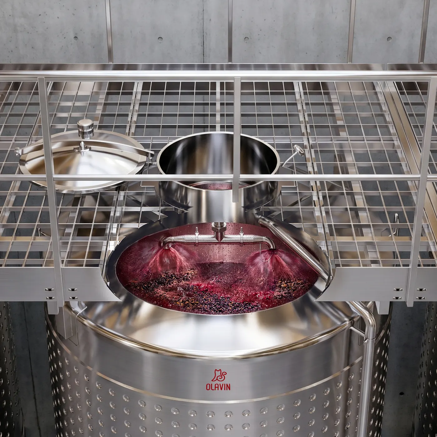 A pump-over running into the open top of an enclosed fermenter, seen from the catwalk above